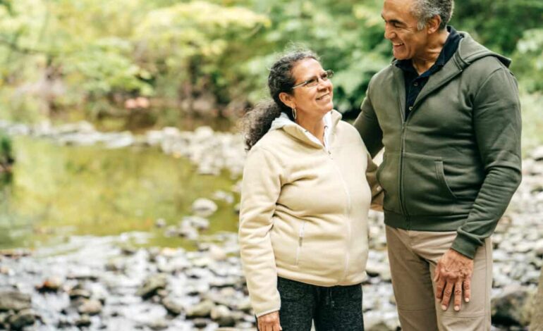 Two seniors walk in the forest